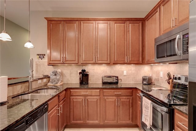 6375 Oxford Cir Unit 104D, Vero Beach, FL 32966 - kitchen featuring dark stone countertops, a sink, appliances with stainless steel finishes, and tasteful backsplash