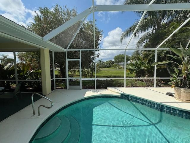 pool with a patio and a lanai