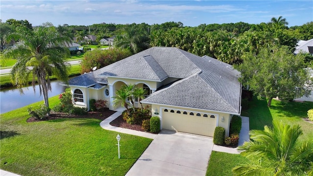 view of front facade featuring driveway, a front lawn, a garage, and stucco siding