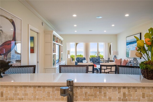 kitchen featuring light stone countertops and ornamental molding