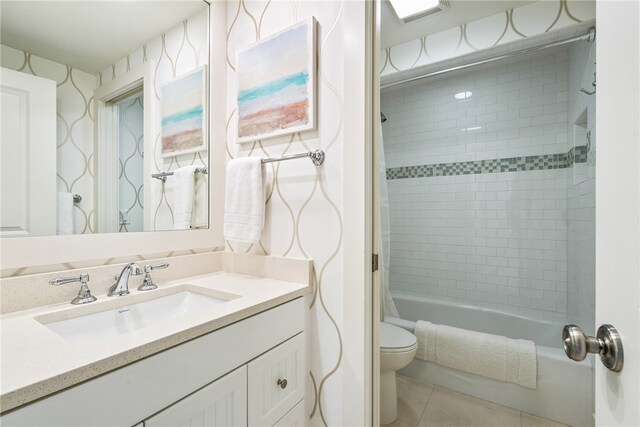 full bathroom with shower / bath combo, tile patterned flooring, vanity, and toilet