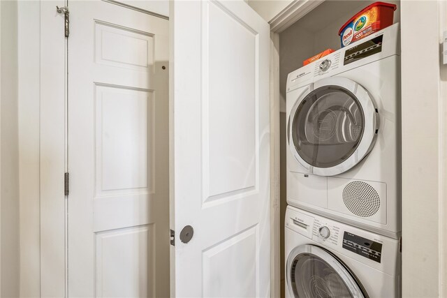 washroom featuring stacked washer / dryer