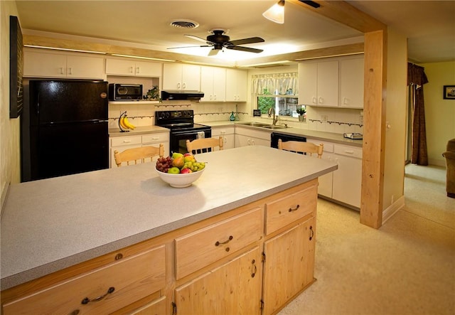 kitchen featuring a ceiling fan, visible vents, black appliances, under cabinet range hood, and light countertops