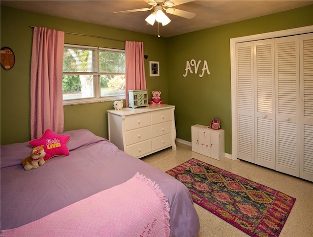 bedroom featuring a closet, baseboards, a ceiling fan, and light speckled floor