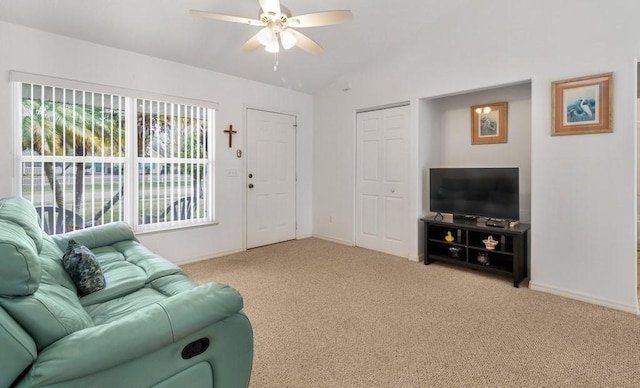 carpeted living room with vaulted ceiling and ceiling fan