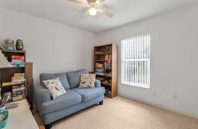 living room featuring ceiling fan and light colored carpet