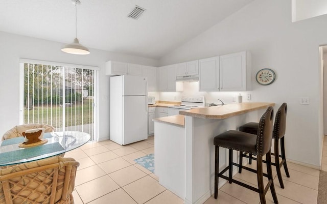 kitchen with white appliances, a breakfast bar area, white cabinetry, hanging light fixtures, and kitchen peninsula