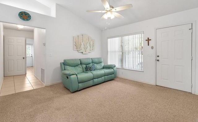 carpeted living room with ceiling fan and lofted ceiling