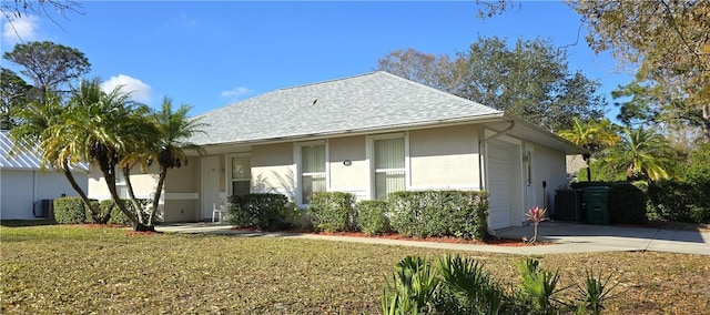 exterior space featuring a garage and a front lawn