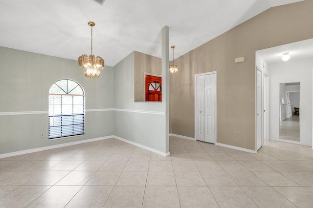 tiled spare room with lofted ceiling and a chandelier