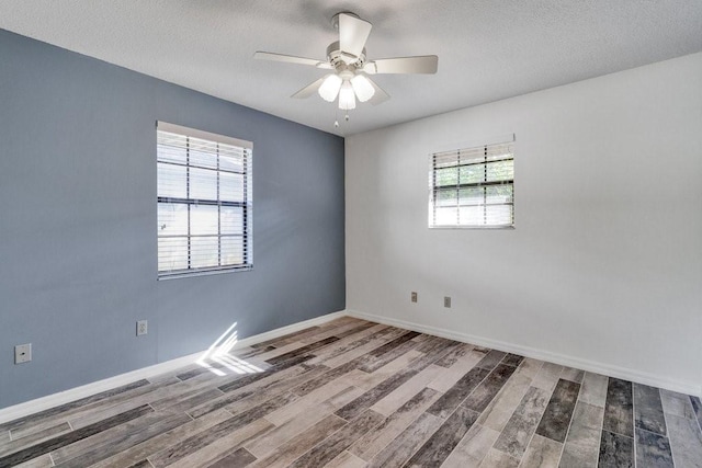 unfurnished room with a textured ceiling, hardwood / wood-style flooring, plenty of natural light, and ceiling fan