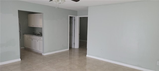 412 7th Rd SW, Vero Beach, FL 32962 - unfurnished room featuring ceiling fan, light tile patterned floors, baseboards, and a sink