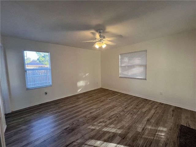 spare room with ceiling fan and dark hardwood / wood-style flooring