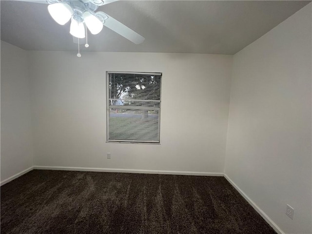 unfurnished room with ceiling fan and dark colored carpet