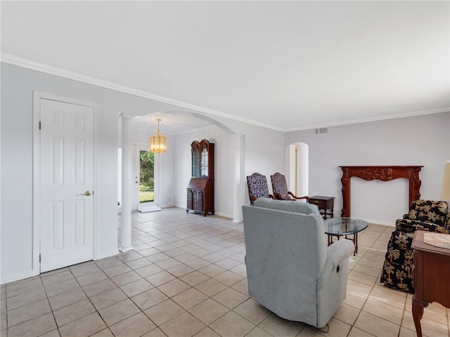 tiled living room featuring an inviting chandelier, ornamental molding, and decorative columns