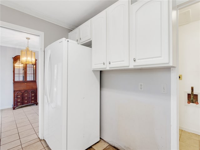 kitchen with white cabinetry, hanging light fixtures, crown molding, and white refrigerator