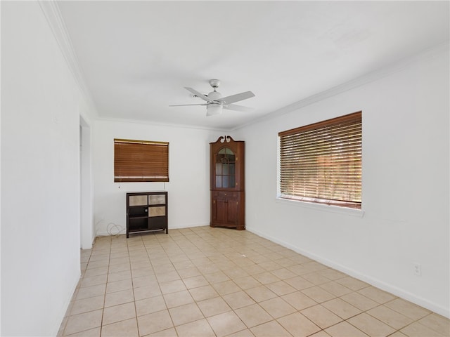 tiled empty room with crown molding and ceiling fan