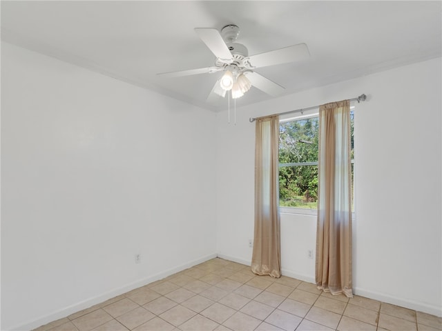 empty room featuring light tile patterned floors and ceiling fan