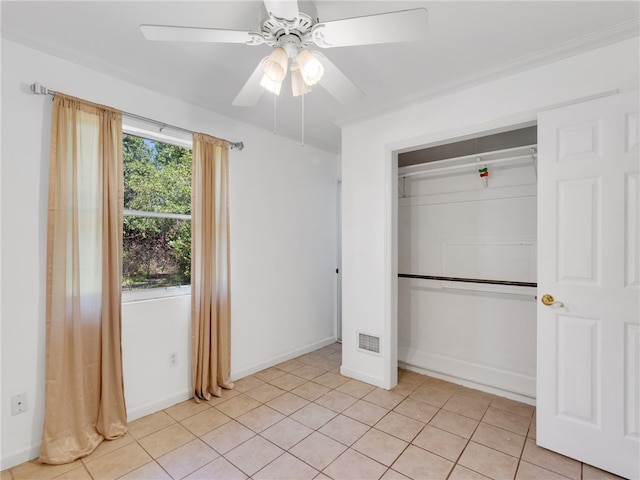 unfurnished bedroom with ceiling fan, a closet, and light tile patterned floors