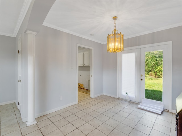 spare room with decorative columns, crown molding, light tile patterned floors, and a notable chandelier