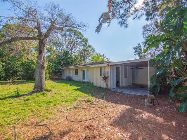 back of property featuring a patio area and a lawn