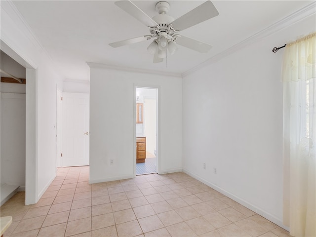 unfurnished bedroom with ornamental molding, a closet, ceiling fan, and light tile patterned flooring