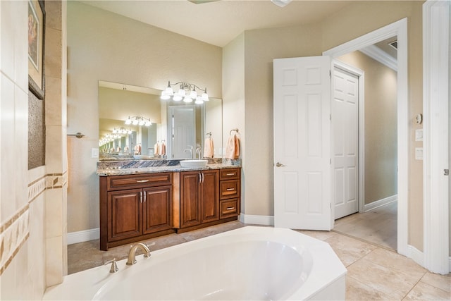 bathroom featuring tile patterned floors, vanity, crown molding, and a bathing tub