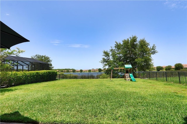 1782 Berkshire Cir SW, Vero Beach, FL 32968 - fenced backyard featuring a playground and a water view