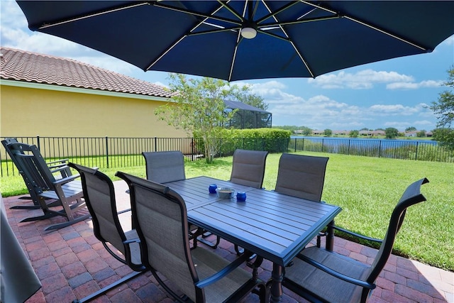 1782 Berkshire Cir SW, Vero Beach, FL 32968 - fenced backyard with outdoor dining space, a patio area, and a water view