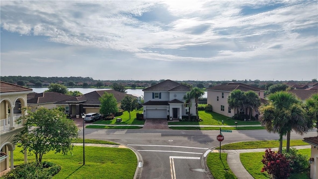 1782 Berkshire Cir SW, Vero Beach, FL 32968 - view of asphalt road featuring traffic signs, curbs, sidewalks, a residential view, and a water view