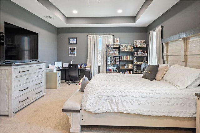 1782 Berkshire Cir SW, Vero Beach, FL 32968 - bedroom with light colored carpet, a tray ceiling, and a desk