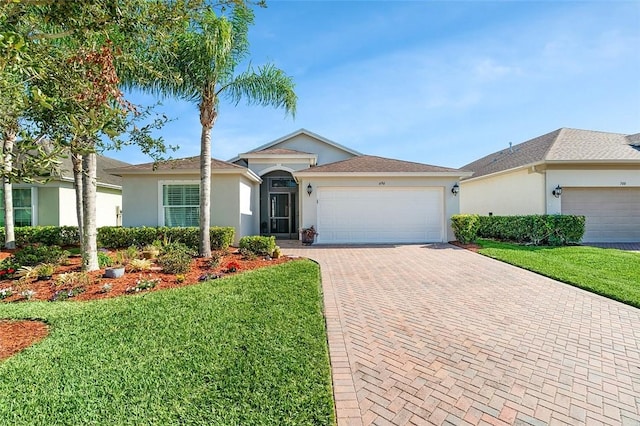 ranch-style home with a front lawn and a garage