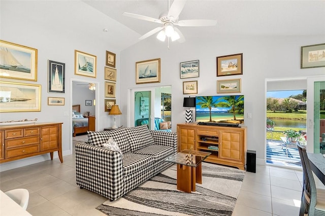 sitting room with lofted ceiling, ceiling fan, and light tile patterned flooring