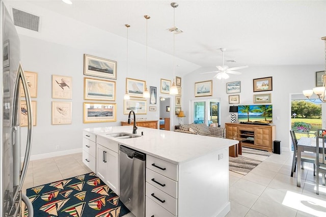 kitchen with sink, white cabinetry, hanging light fixtures, a kitchen island with sink, and appliances with stainless steel finishes