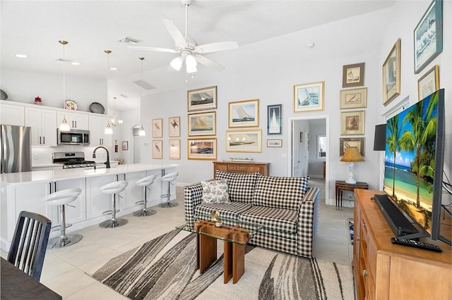 living room featuring high vaulted ceiling, ceiling fan, and light tile patterned floors