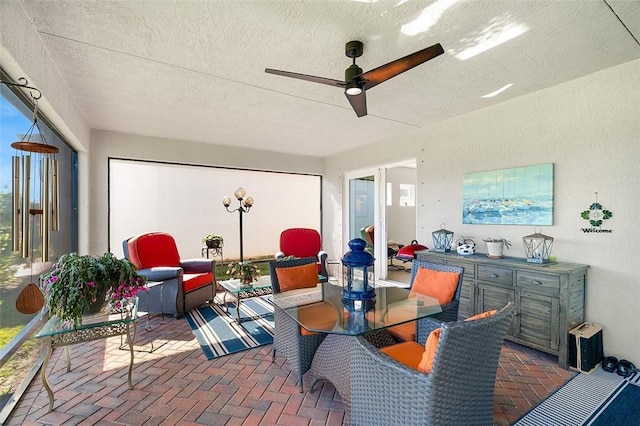 interior space with ceiling fan and a textured ceiling