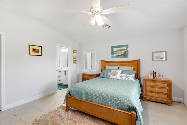 bedroom featuring ceiling fan, connected bathroom, lofted ceiling, and light tile patterned floors