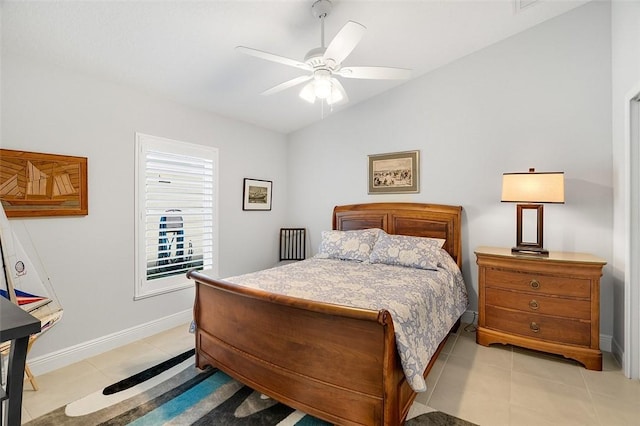 tiled bedroom with lofted ceiling and ceiling fan