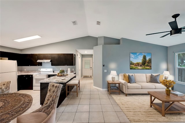 tiled living room featuring ceiling fan and vaulted ceiling