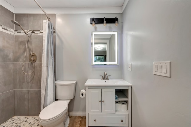 bathroom featuring toilet, vanity, hardwood / wood-style floors, and walk in shower