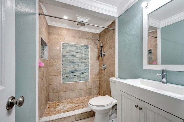 bathroom featuring vanity, toilet, tiled shower, and crown molding