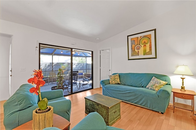 living room with hardwood / wood-style flooring and lofted ceiling