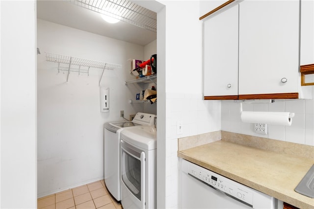 clothes washing area with light tile patterned floors and washing machine and clothes dryer