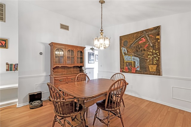 dining room with a chandelier and light wood-type flooring