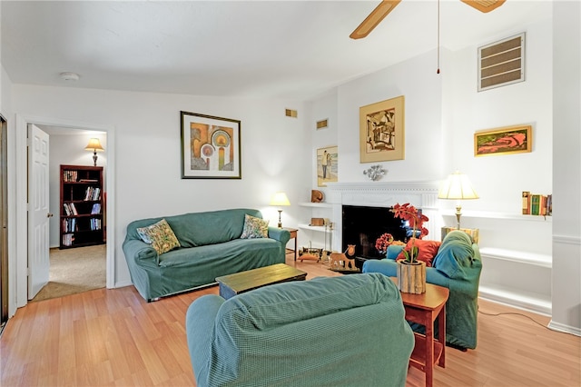 living room featuring hardwood / wood-style flooring and ceiling fan