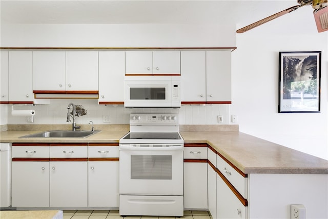 kitchen featuring sink, light tile patterned floors, white appliances, decorative backsplash, and white cabinets