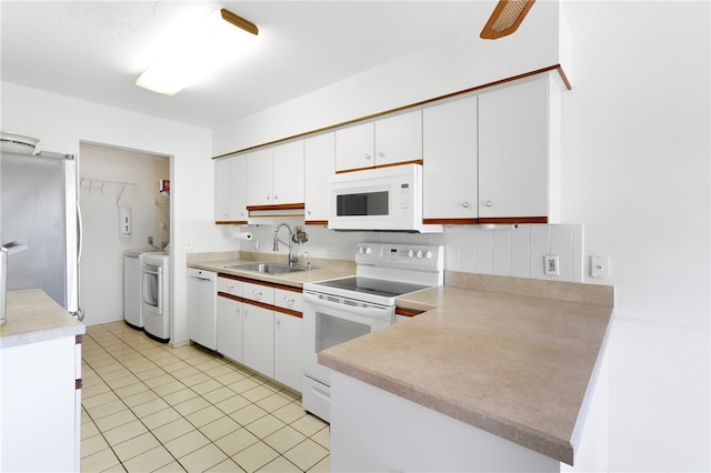 kitchen with white appliances, sink, separate washer and dryer, white cabinetry, and light tile patterned flooring