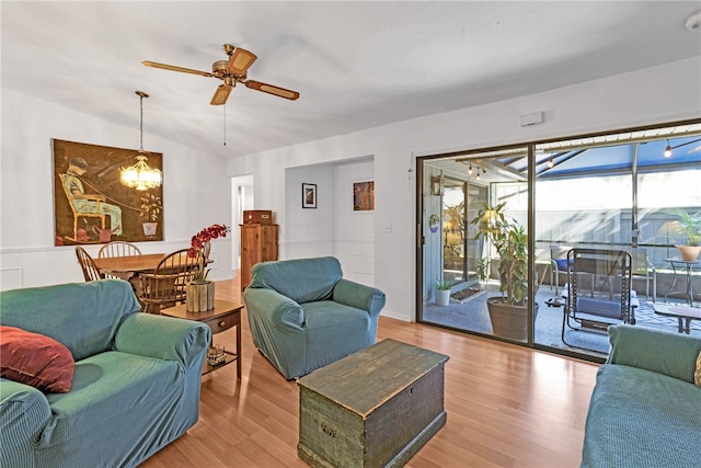 living room featuring ceiling fan, light wood-type flooring, and lofted ceiling