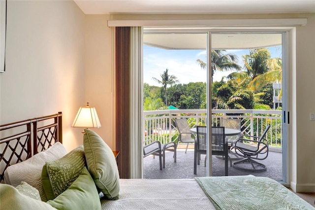 bedroom with access to outside, multiple windows, and carpet flooring