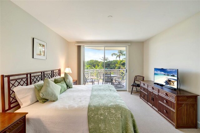 bedroom with access to exterior and light colored carpet